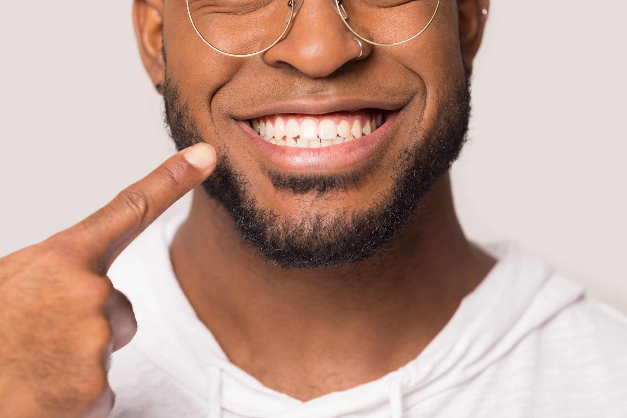 Close Up Of Biracial Man Show White Healthy Teeth